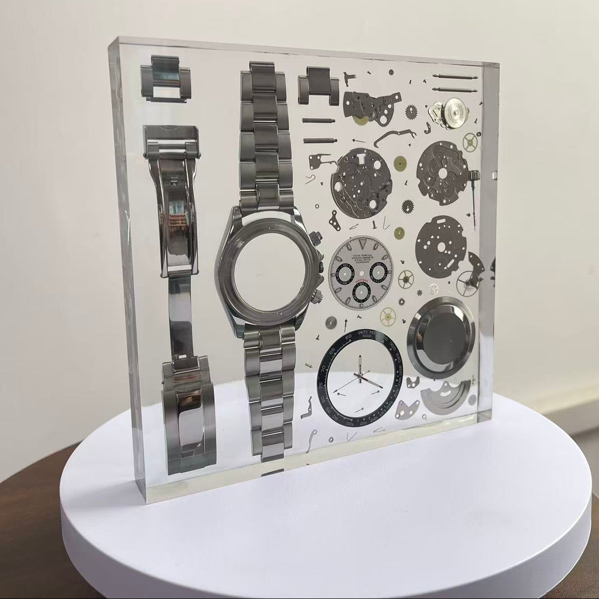 Resin display case with decomposed watch parts and braclet