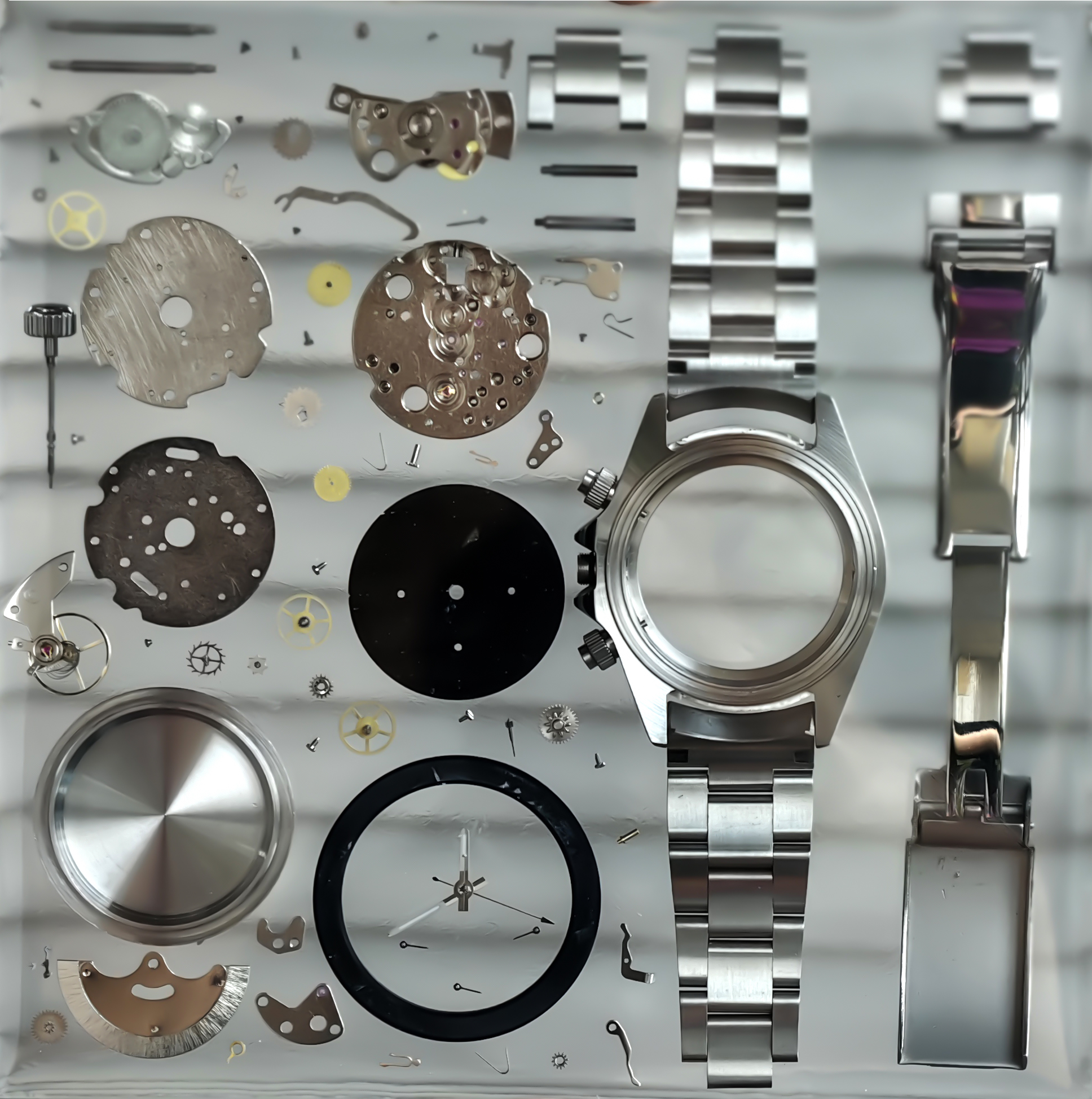 Silver watch components and parts on a metallic background Timepiece Craft 
