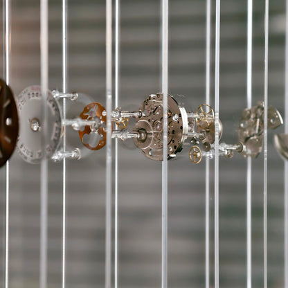 Close-up of mechanical clock gears behind fiber glass