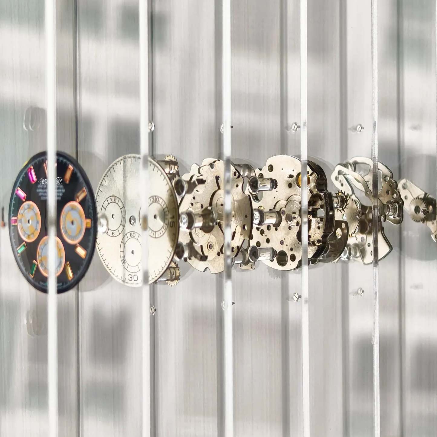 Collection of mechanical watch components on a metallic background