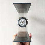 Hand holding a transparent stand with a panda model wristwatch on a white background