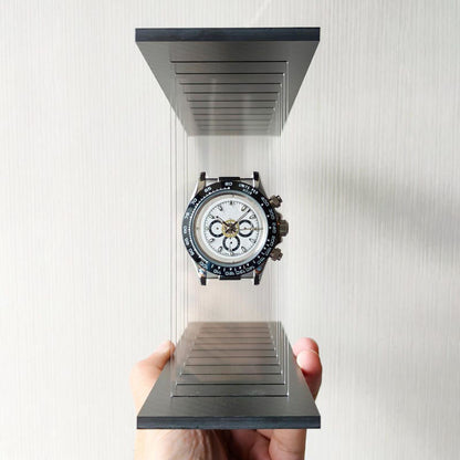 Hand holding a transparent stand with a panda model wristwatch on a white background